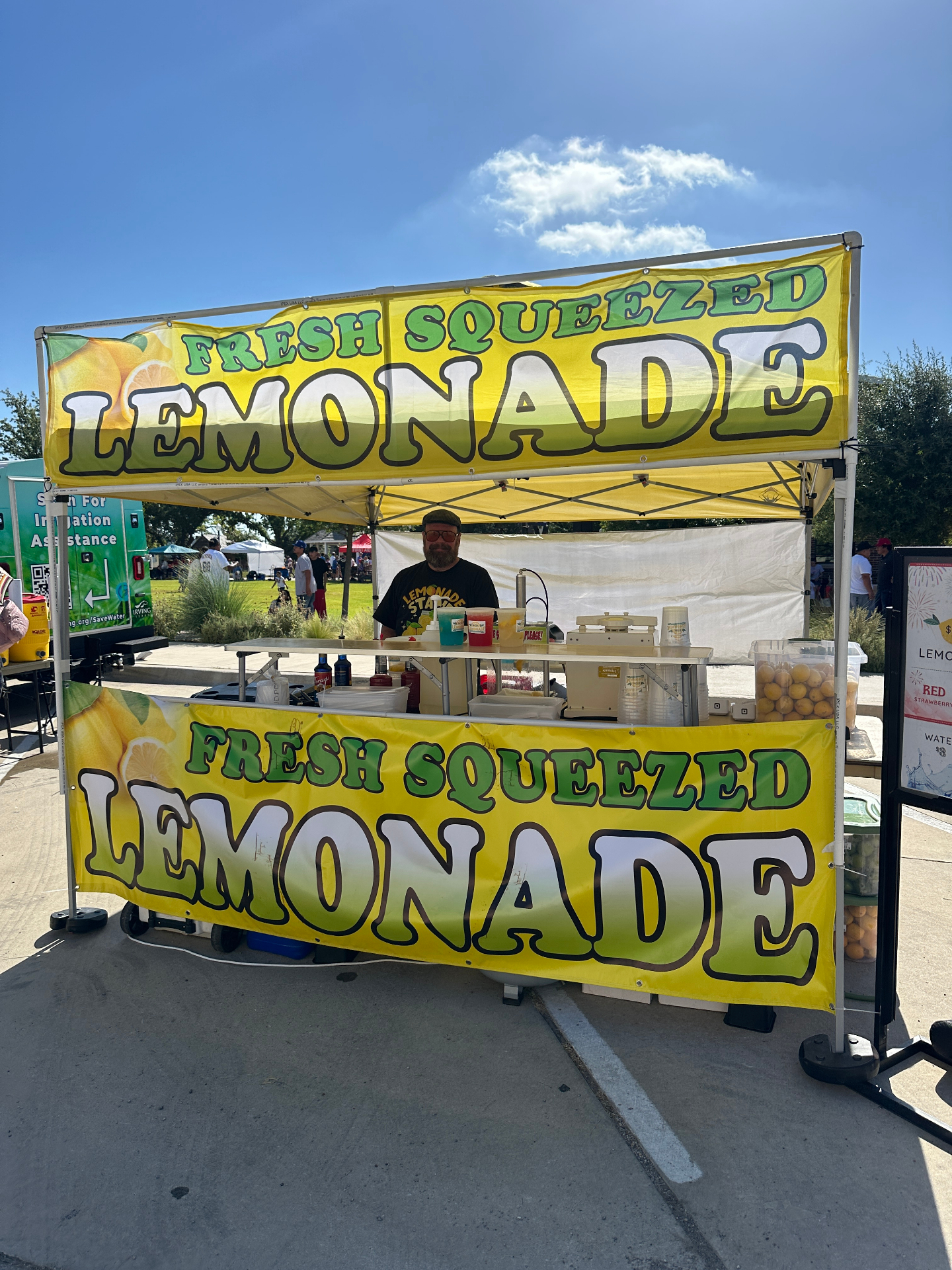 Classic yellow lemonade stand at outdoor festival