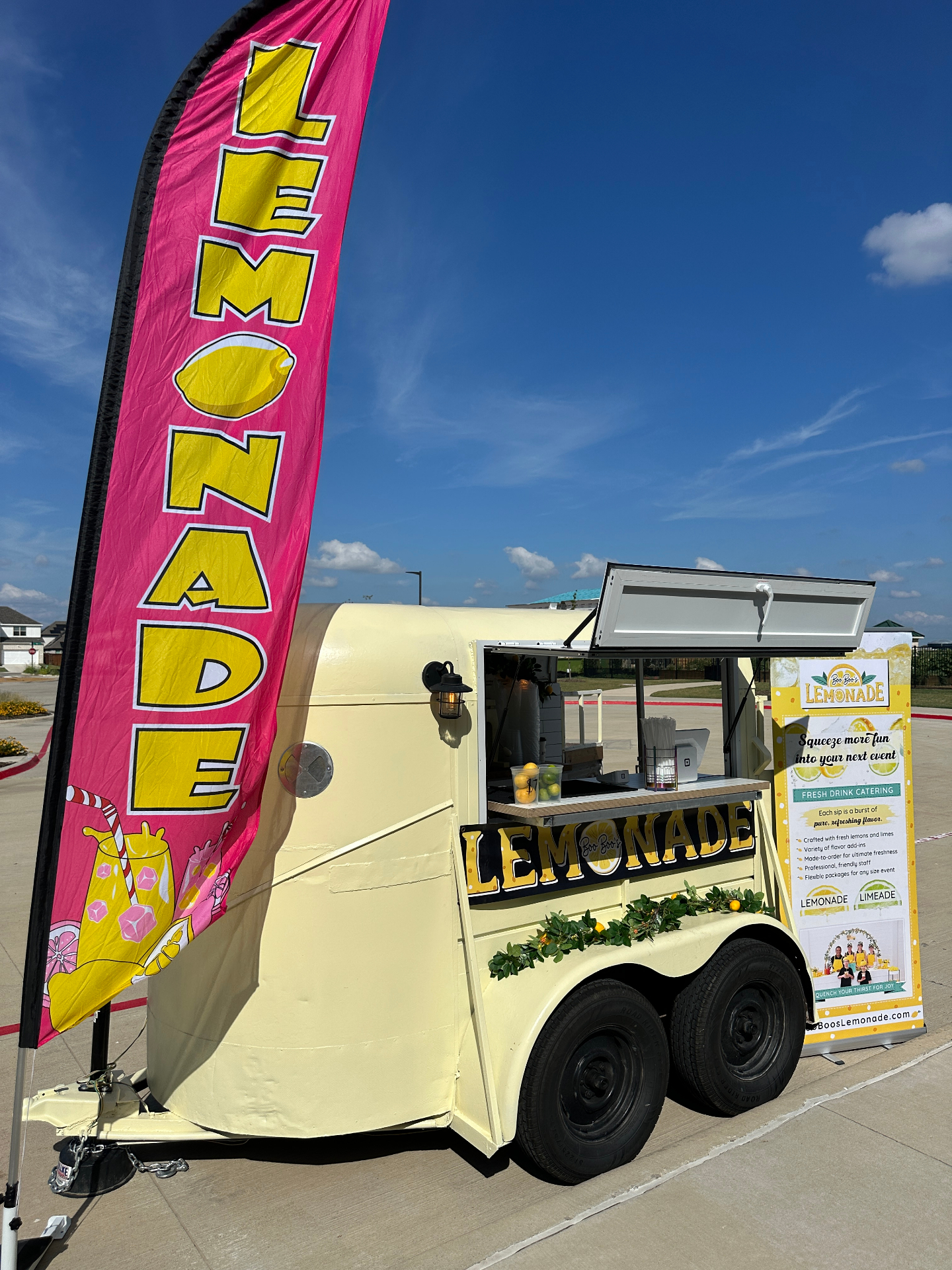 Cream trailer with pink lemonade flag and menu board