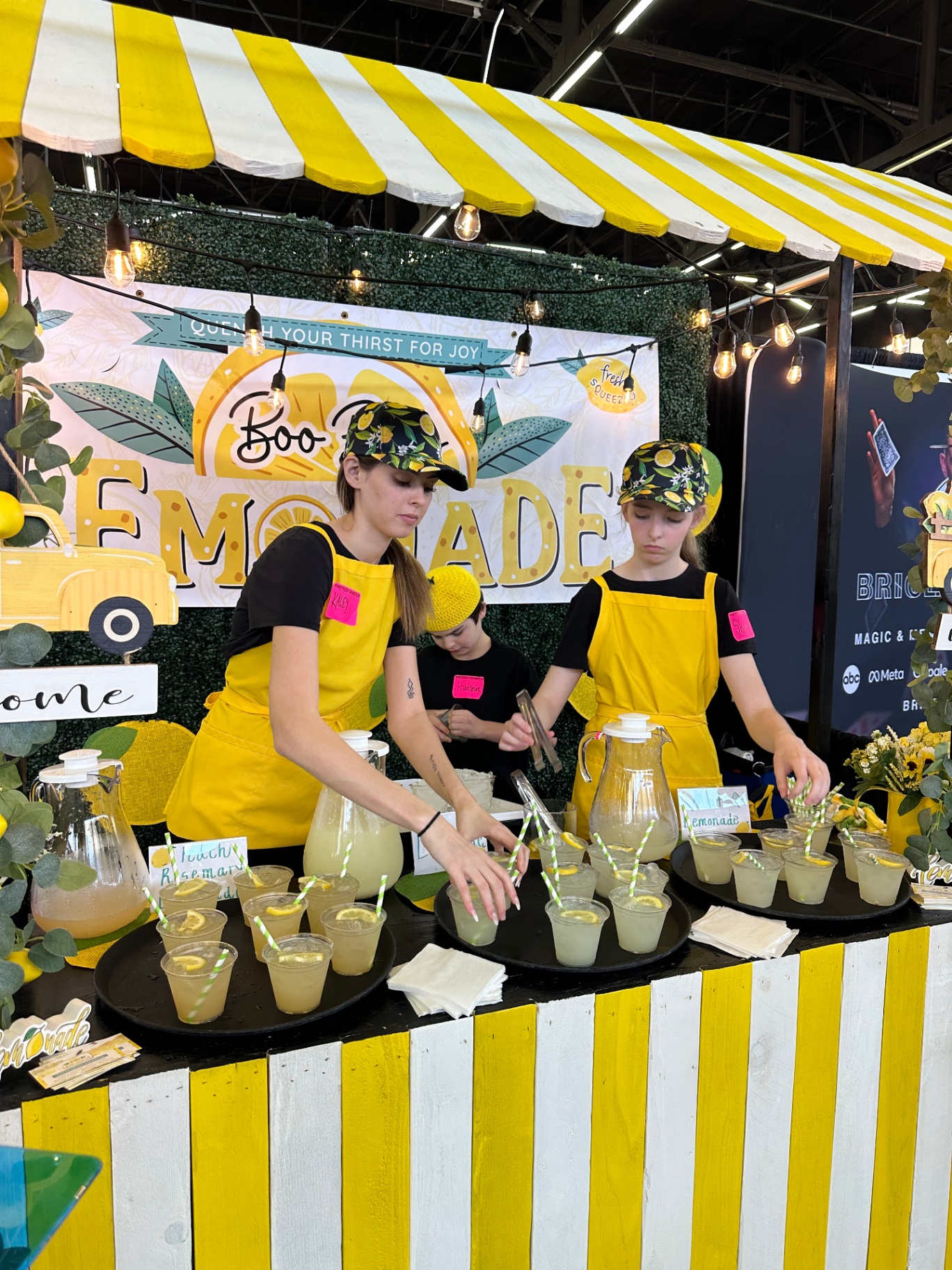 Team serving lemonade at indoor expo booth