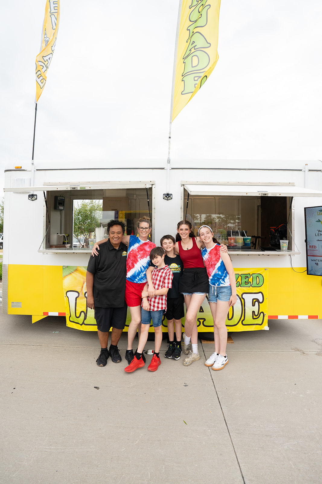 Family group photo in front of the lemonade trailer