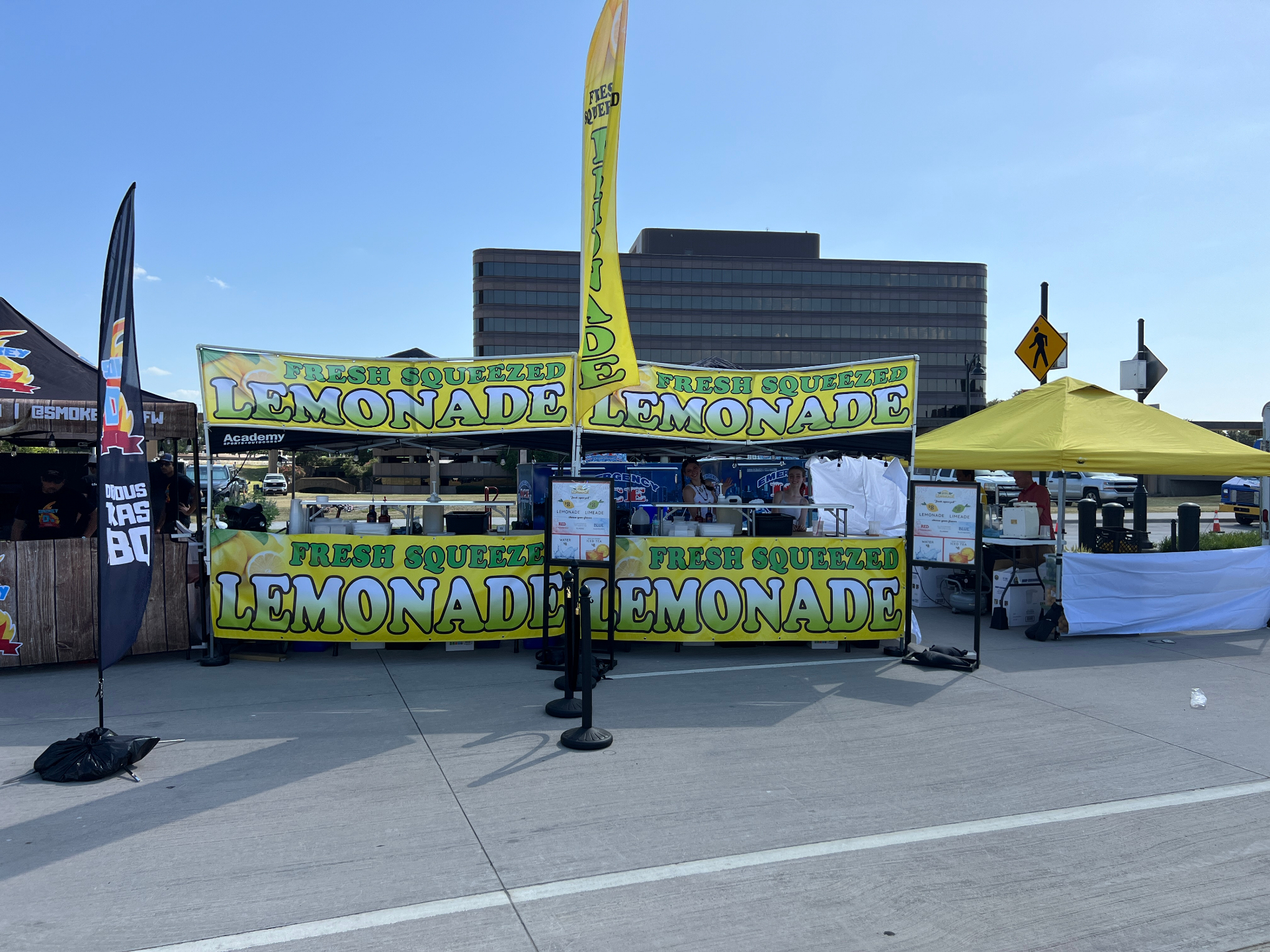 Wide outdoor festival booth with fresh squeezed signage