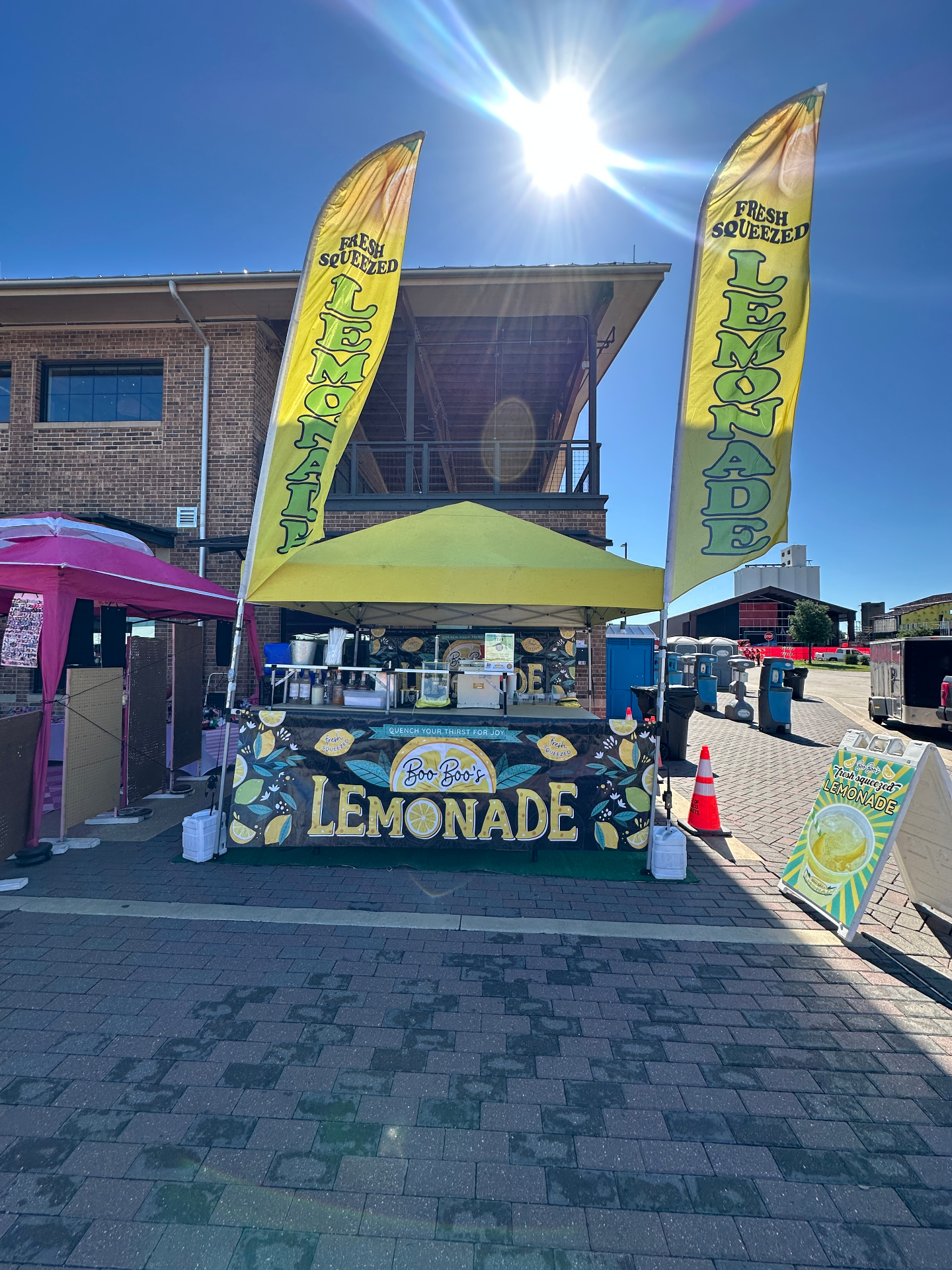 Lemonade stand with tall feather flags