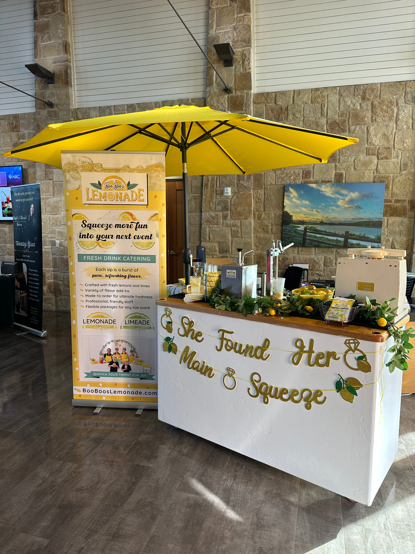 Wedding-themed lemonade cart with yellow umbrella