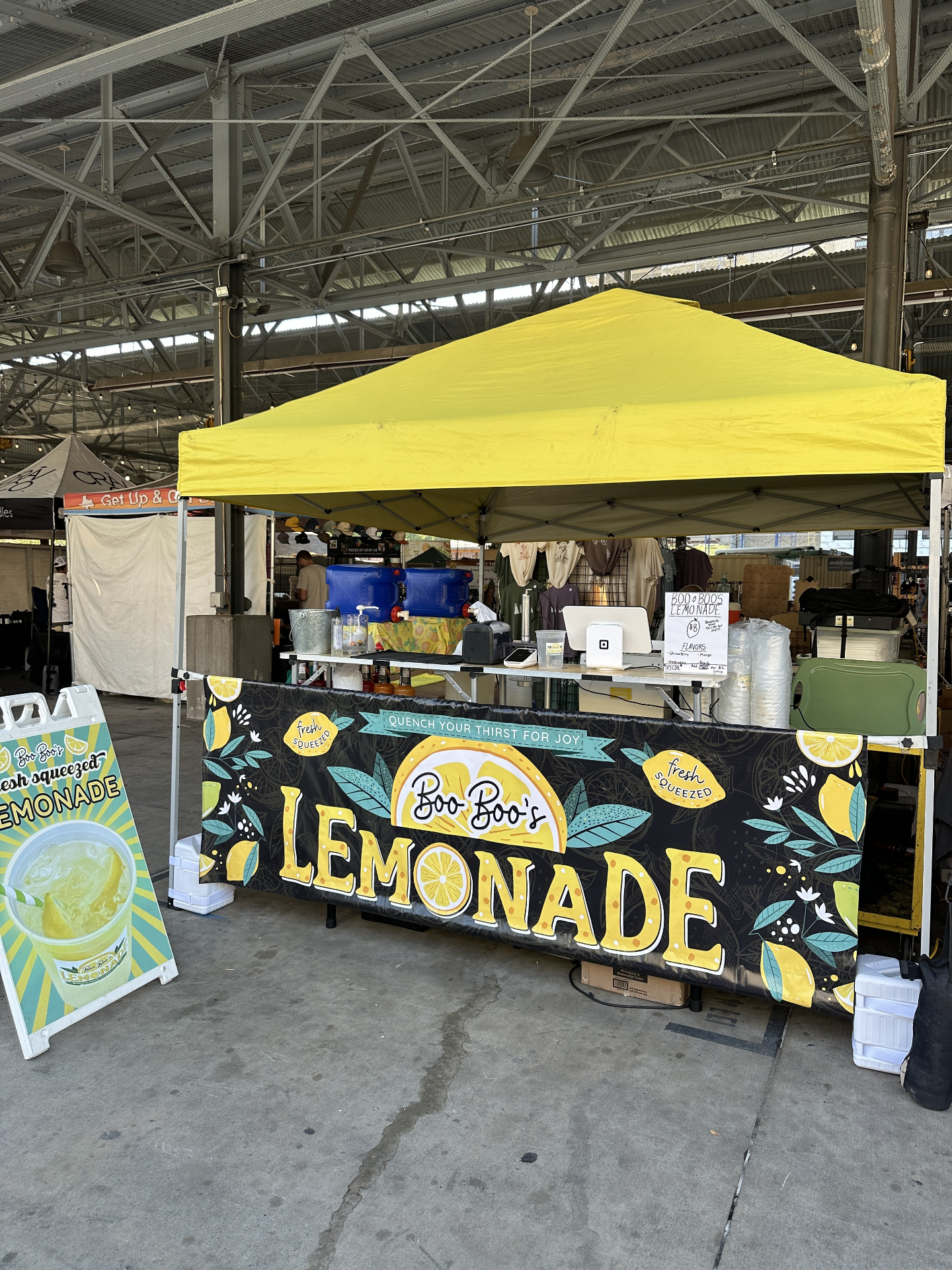 Boo Boo's Lemonade tent setup at indoor market