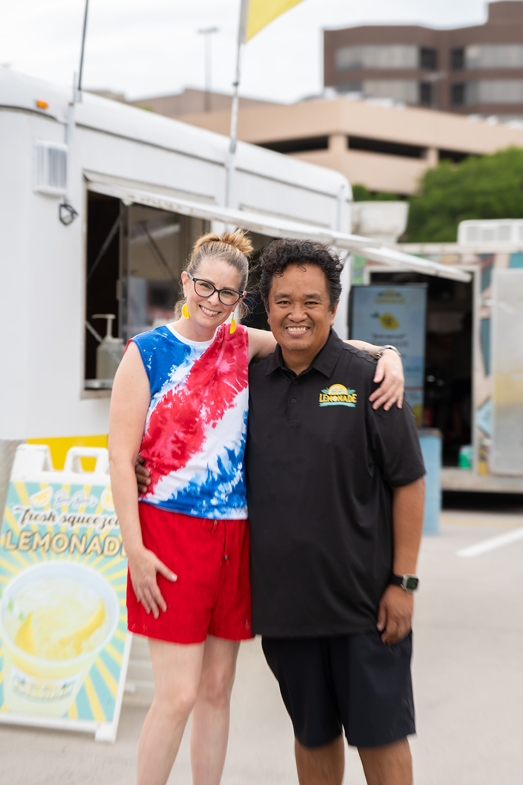 Owner portrait beside the lemonade trailer
