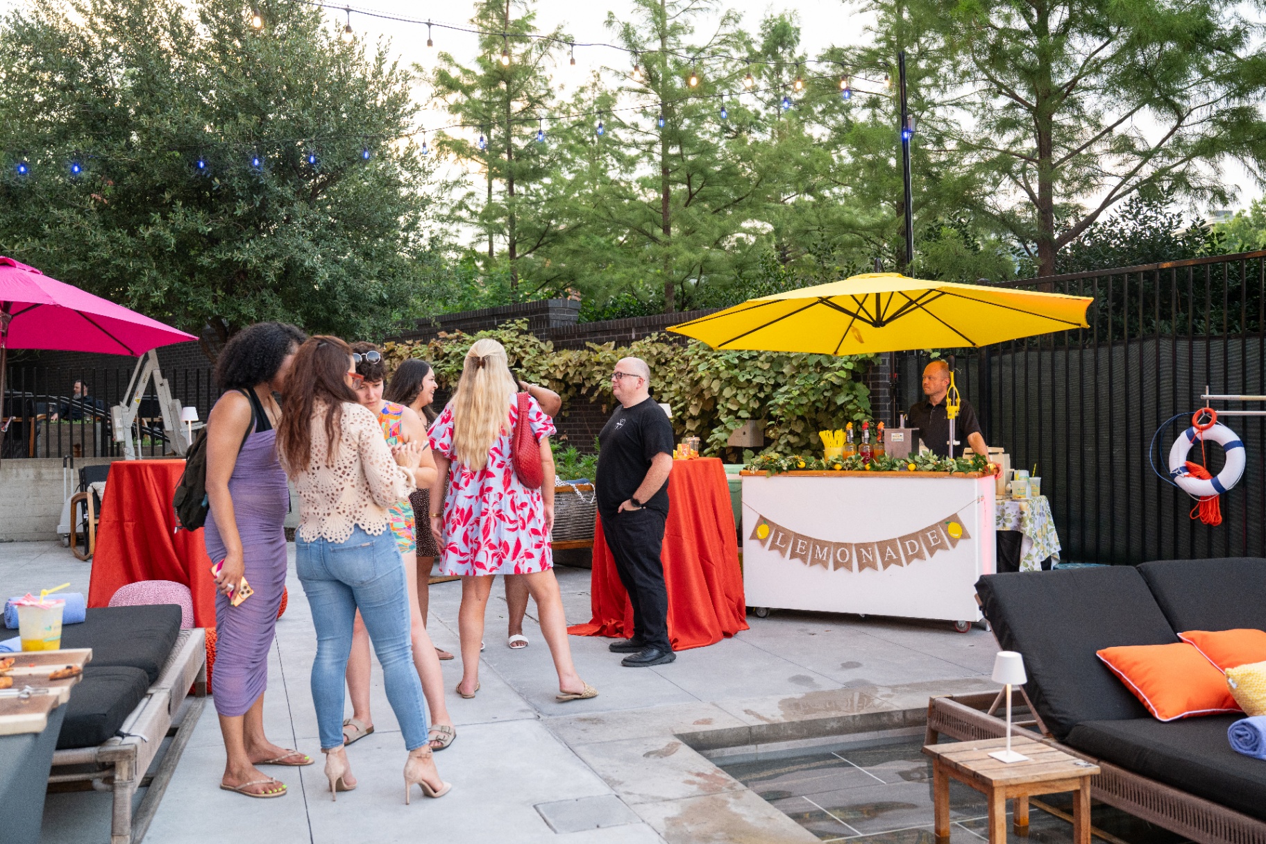 Guests mingling near the poolside lemonade bar