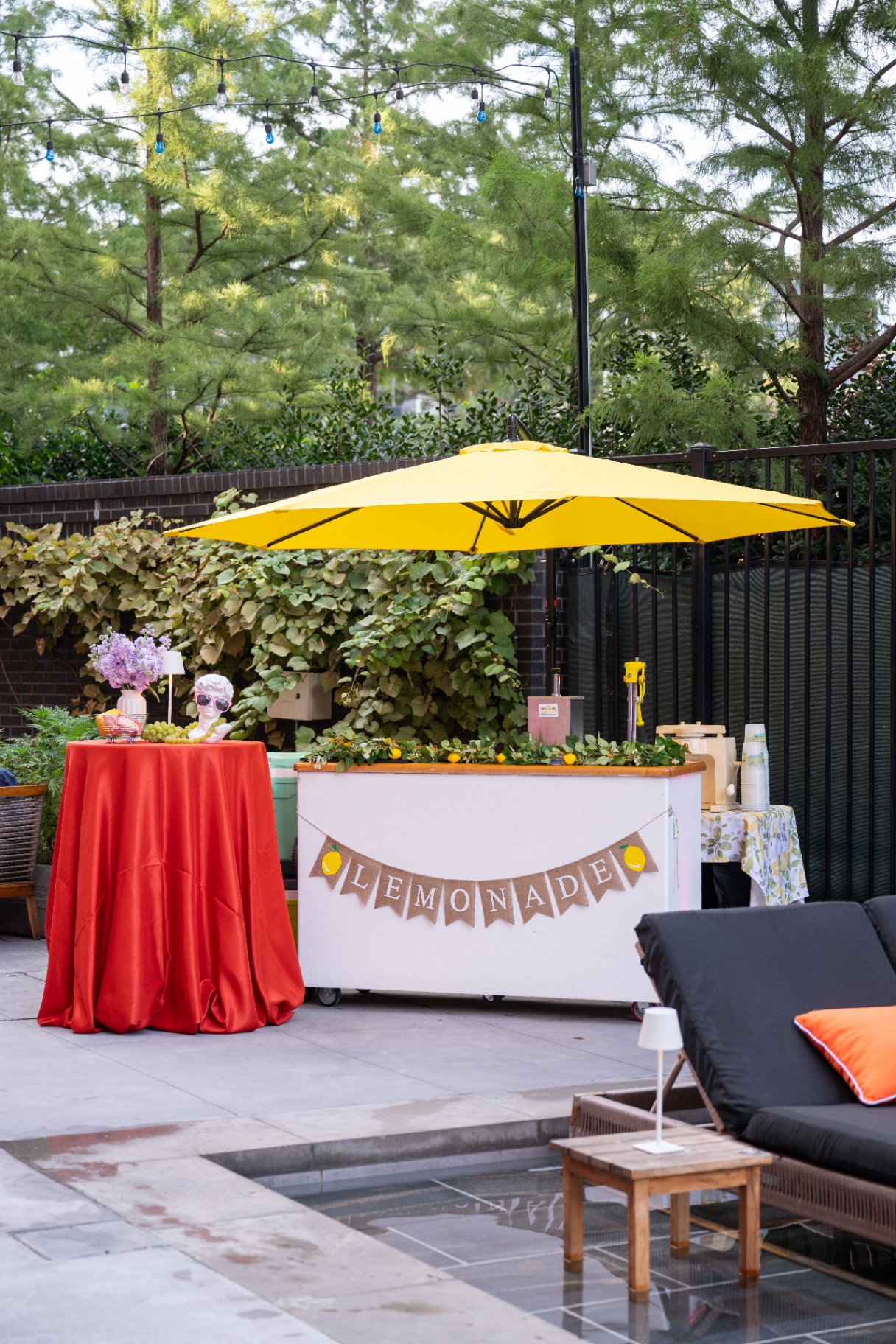 Poolside lemonade bar with bright yellow umbrella