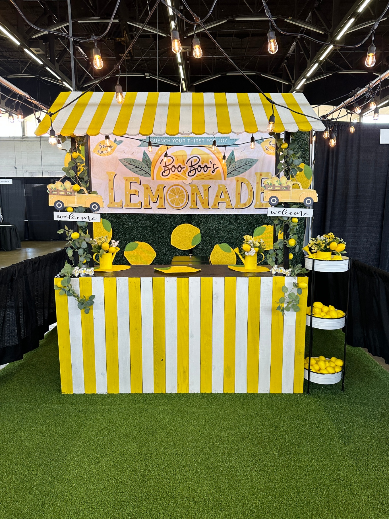 Striped booth decorated with lights and lemons