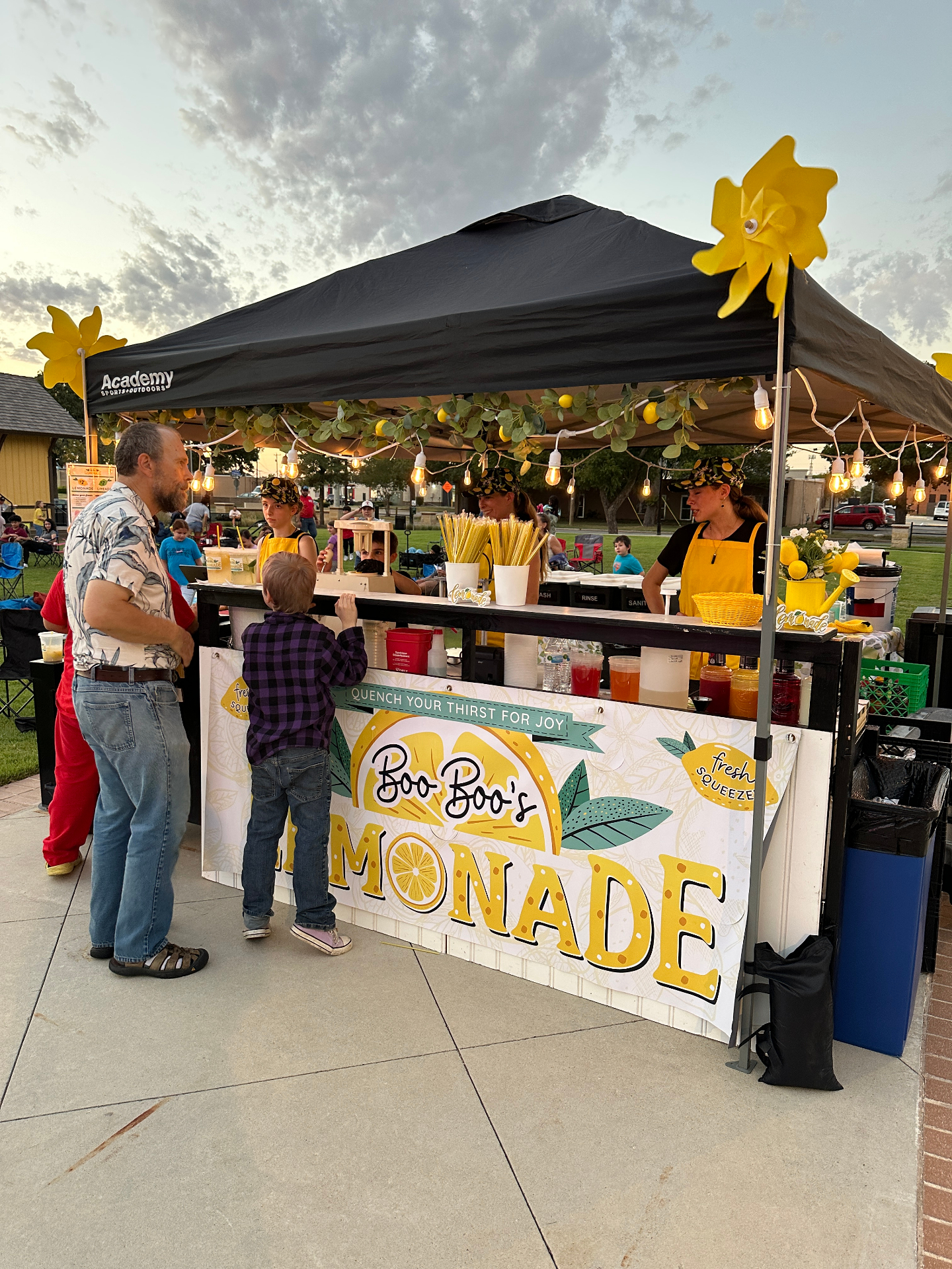 Customers ordering lemonade at sunset event
