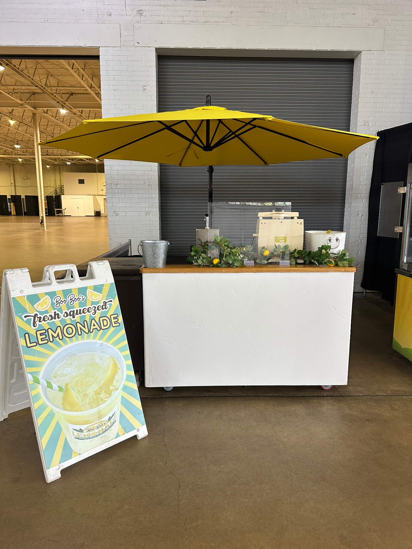Minimal white booth with yellow umbrella